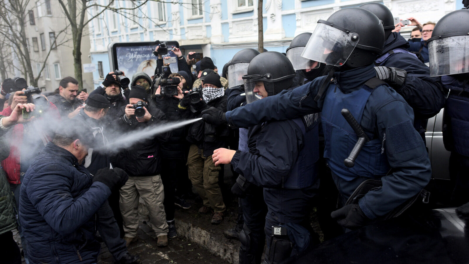 Police use tear gas as they clash with supporters of former Georgian president Mikheil Saakashvili in Kiev, Ukraine, Dec. 5, 2017. Hundreds of protesters chanting "Kiev, rise up!" blocked Ukrainian police as they tried to arrest former Georgian president Mikheil Saakashvili on Tuesday. (AP/Evgeniy Maloletka)