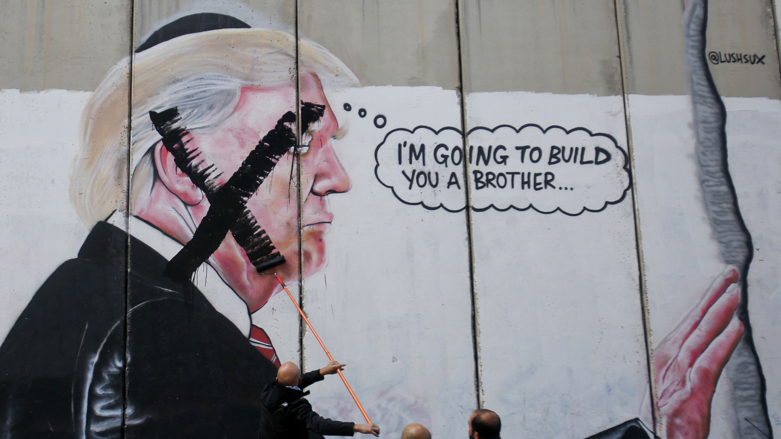 A Palestinian man paints over a mural of the U.S. President Donald Trump during a protest in Bethlehem in the Israeli occupied West Bank, Dec. 7, 2017. Defying dire, worldwide warnings, Donald Trump on Wednesday broke with decades of U.S. and international policy by recognizing Jerusalem as Israel's capital. (AP/Nasser Shiyoukhi)