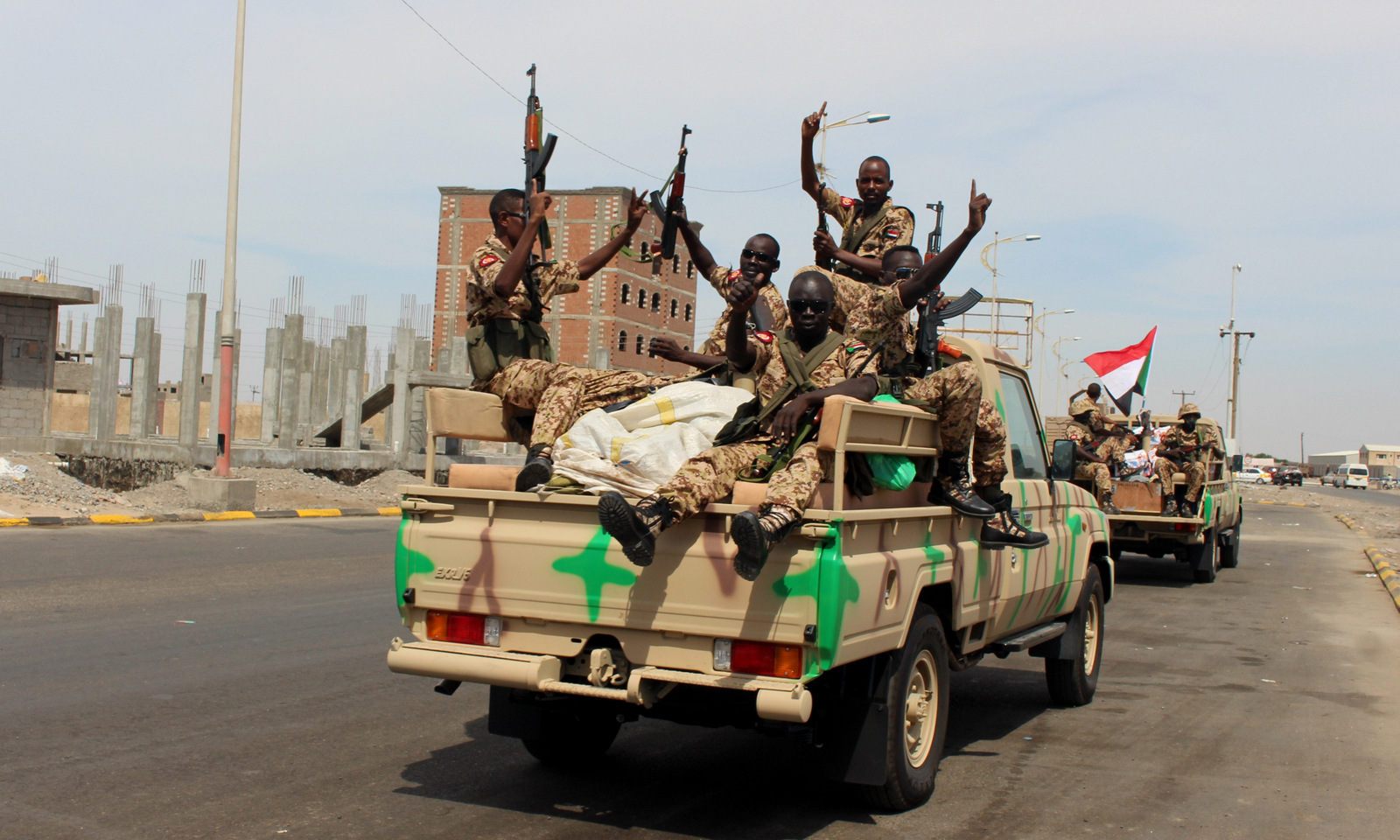 Sudanese soldiers on a military vehicle gesture as they arrive to the port city of Aden, Yemen, Nov. 9, 2015. (AP/Wael Qubady)