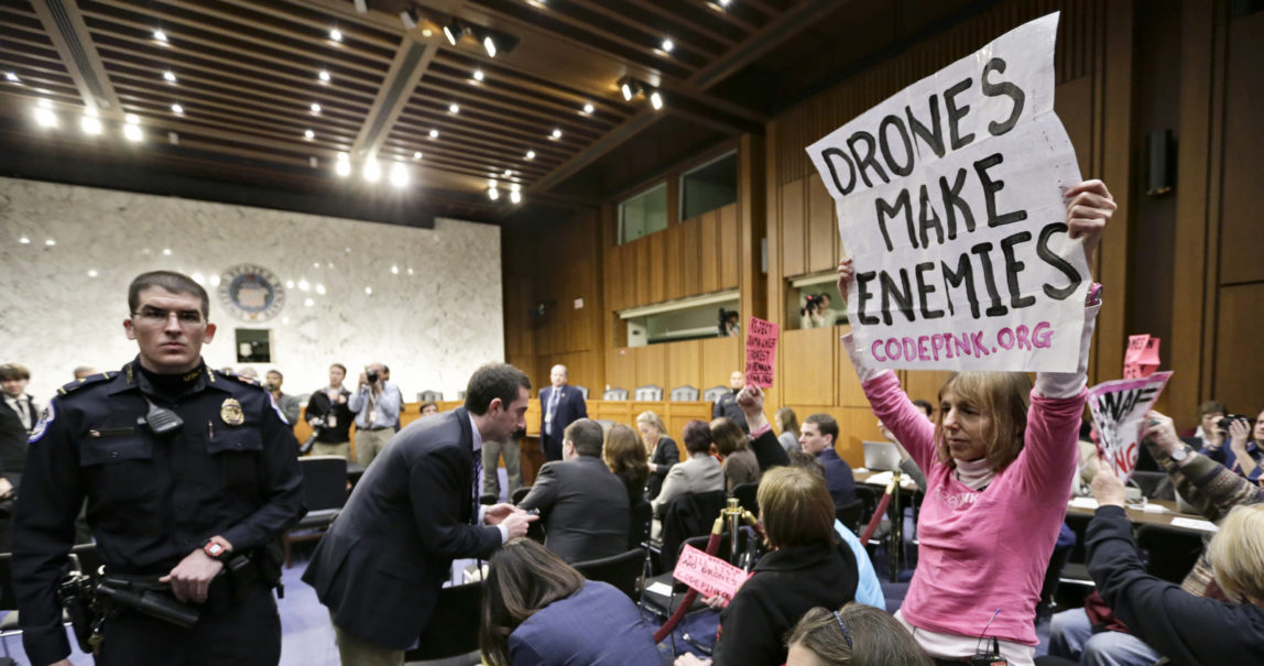 CODEPINK co-founder Medea Benjamin, right and other CODEPINK protestors, a group opposed to U.S. militarism, disrupt the start of the Senate Intelligence Committee confirmation hearing for John Brennan, Thursday, Feb. 7, 2013, on Capitol Hill in Washington. (AP/J. Scott Applewhite)