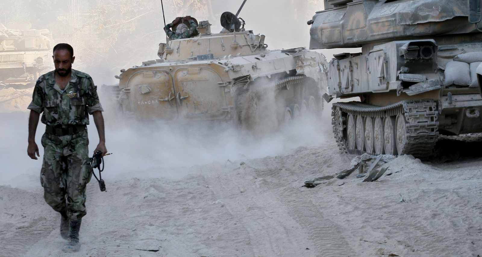 A Syrian army soldier walks on a street in the Jobar neighborhood of Damascus, Syria, August 24, 2013. (AP Photo)