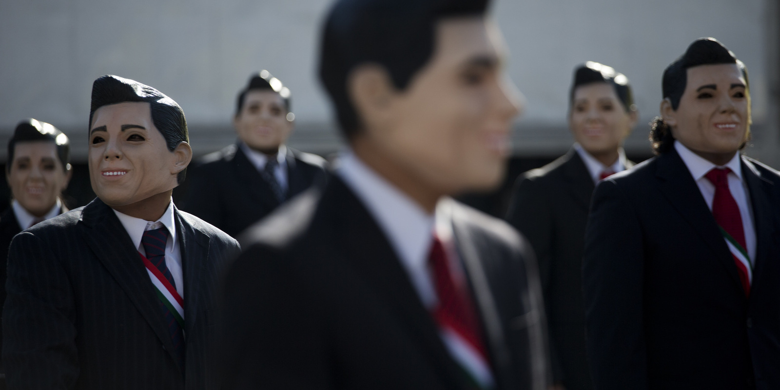 Greenpeace protestors wear masks of Mexican President Enrique Pena Nieto as they demonstrate in front of the National Palace in Mexico City, Oct. 23, 2014. (AP/Rebecca Blackwell)