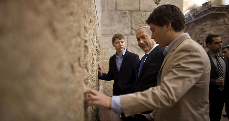 Israeli Prime Minister Benjamin Netanyahu, center, prays with his sons Yair, background, and Avner, right, at the Western Wall in Jerusalem's Old City, Jan. 22, 2013. (AP/Uriel Sinai)