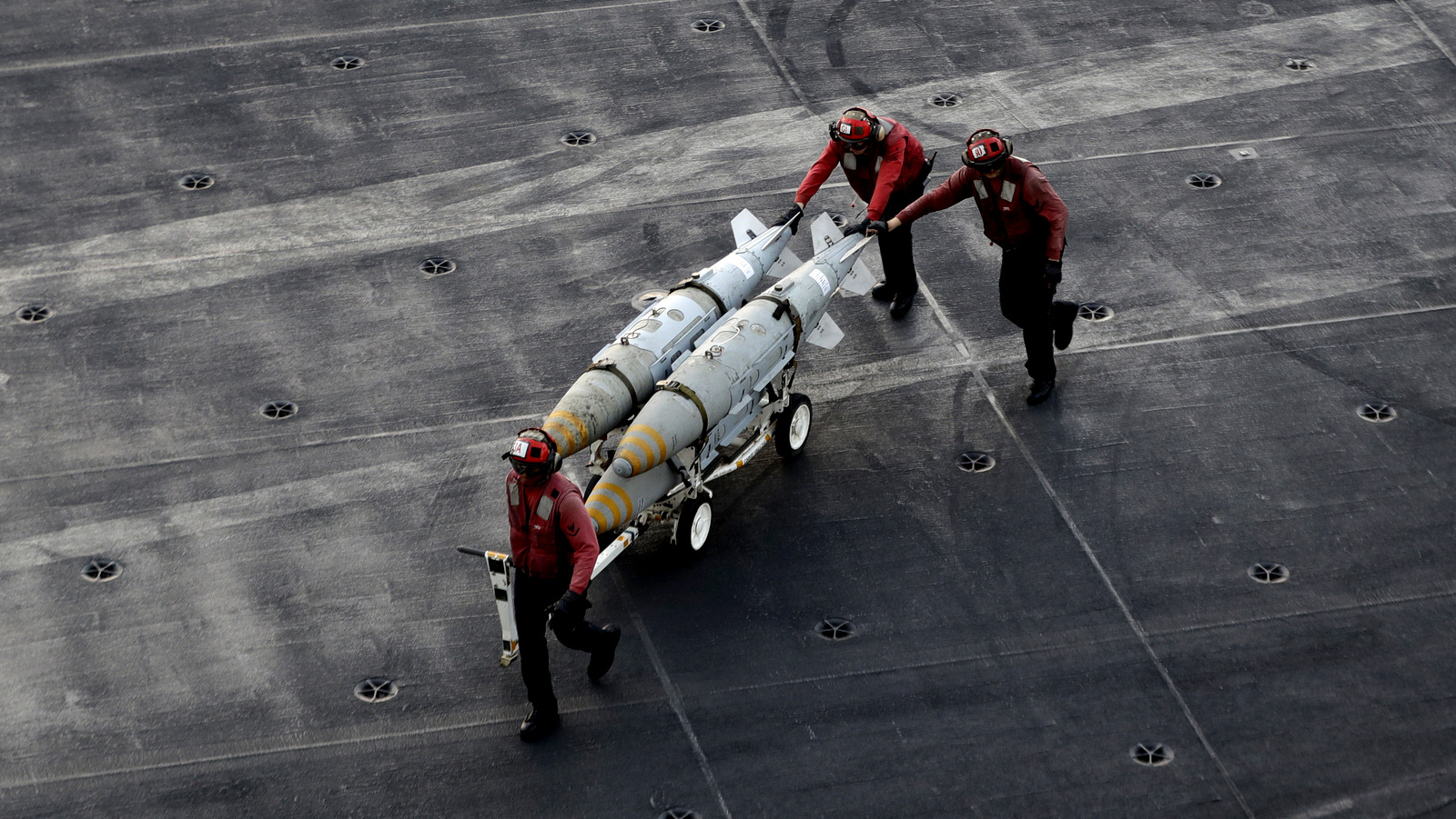 U.S. Navy sailors push bombs across the deck of the U.S.S. Dwight D. Eisenhower aircraft carrier, deployed in the Persian Gulf near Iran. (AP/Petr David Josek)