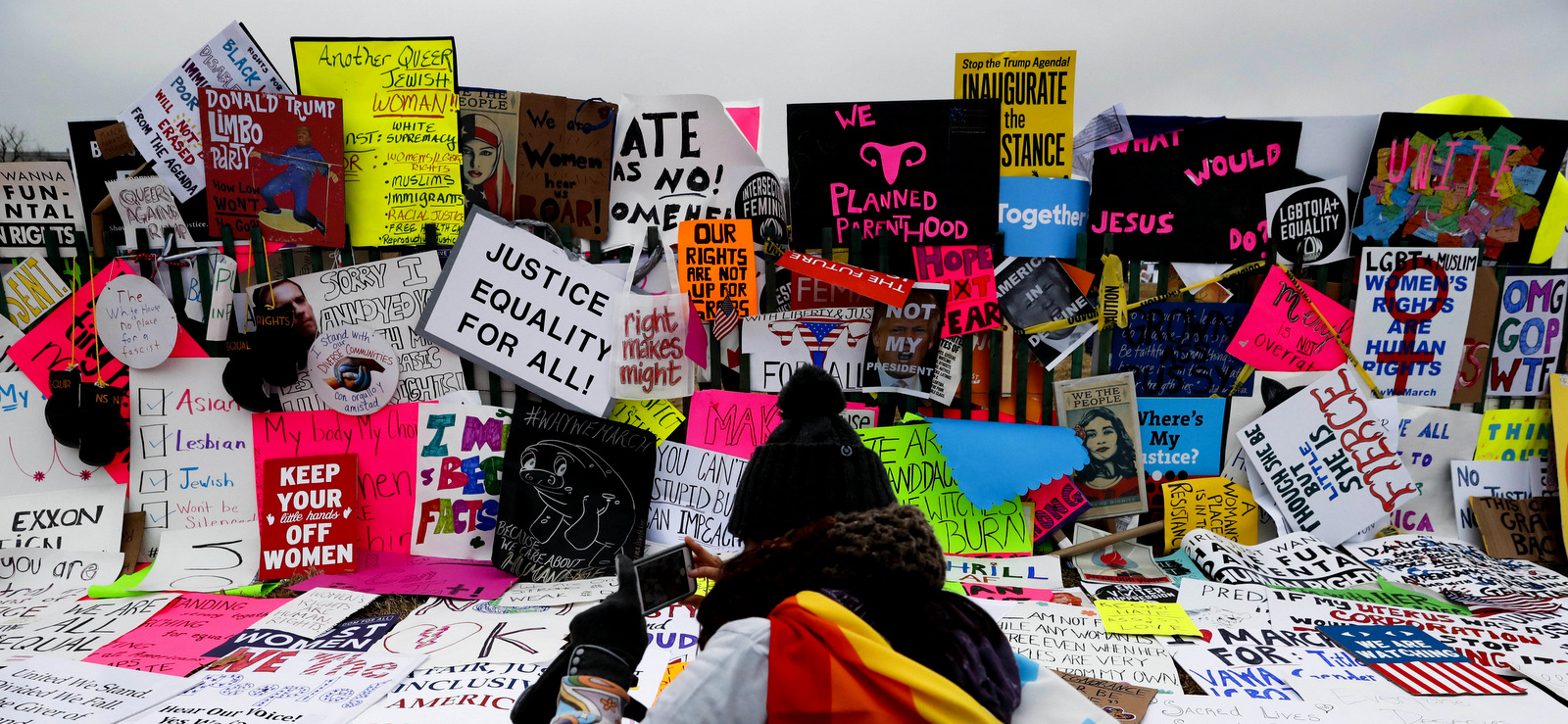 Protesters build a wall of signs outside the White House for the Women's March on Washington during the first full day of Donald Trump's presidency in Washington, Jan. 21, 2017. (AP/John Minchillo)