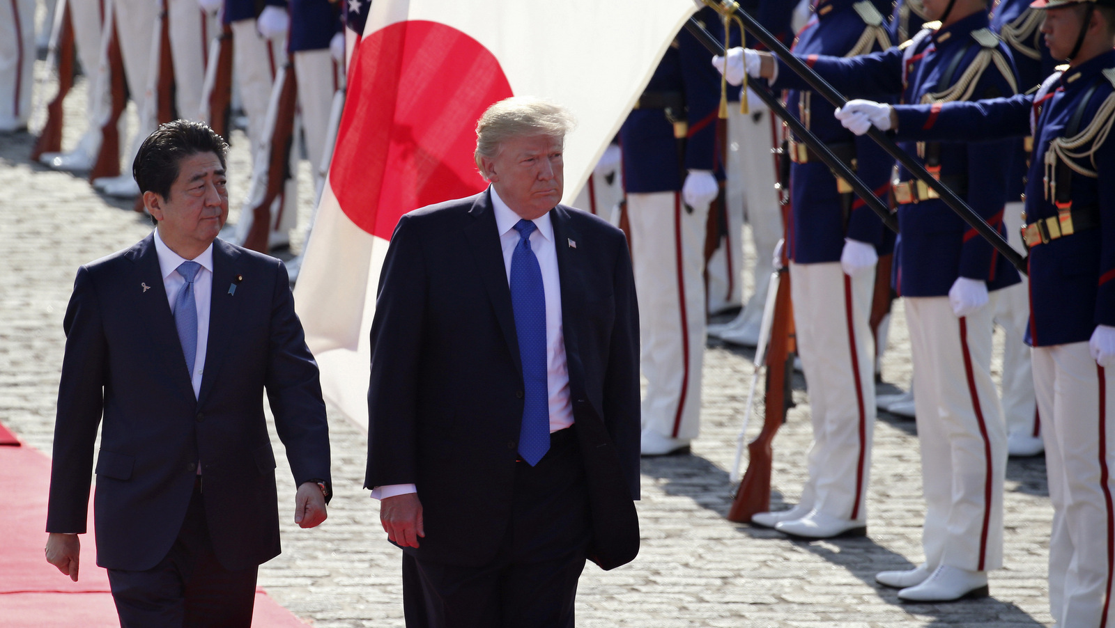 U.S. President Donald Trump reviews an honor guard during a welcome ceremony, escorted by Japanese Prime Minister Shinzo Abe at Akasaka Palace in Tokyo, Nov. 6, 2017. (AP/Koji Sasahara)