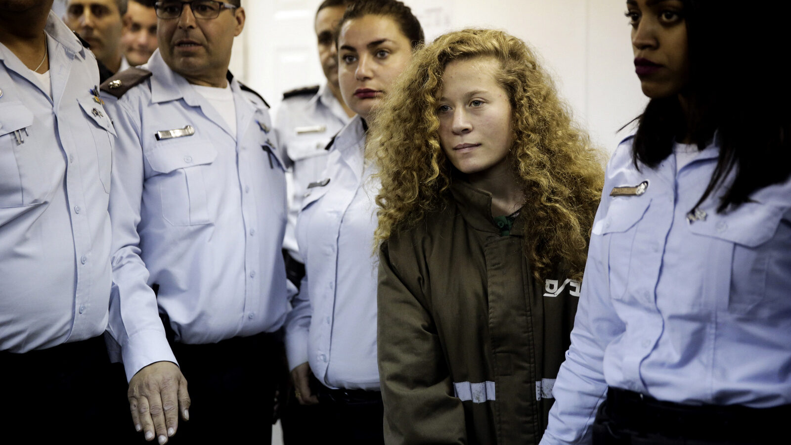 17 year-old Ahed Tamimi is brought to a courtroom inside Ofer military prison near Jerusalem, Dec. 28, 2017. Tamimi was arrested last week for slapping two Israeli soldiers who shot her 15-year old cousin in the face. She faces charges of attacking soldiers. (AP/Mahmoud Illean)