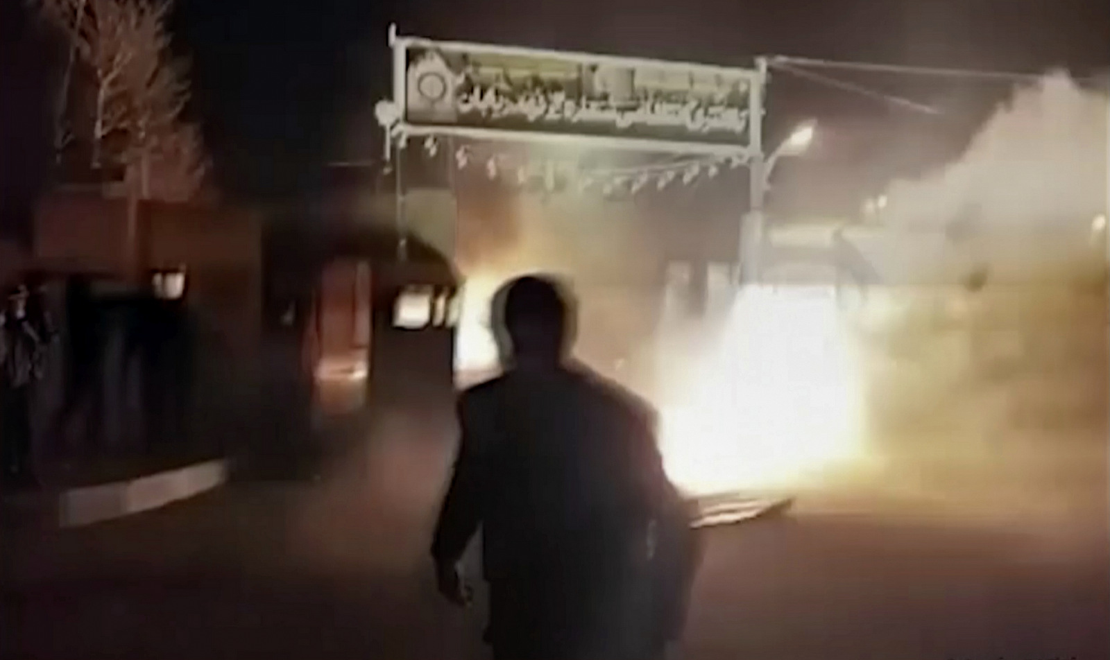 This frame grab from video shows an attack on an Iranian police station in Qahdarijan, Iran, Jan. 2, 2018. Six rioters were killed during the attack on the police station, according to Iranian state TV. It reported that clashes were sparked by rioters who tried to steal guns from the police station.