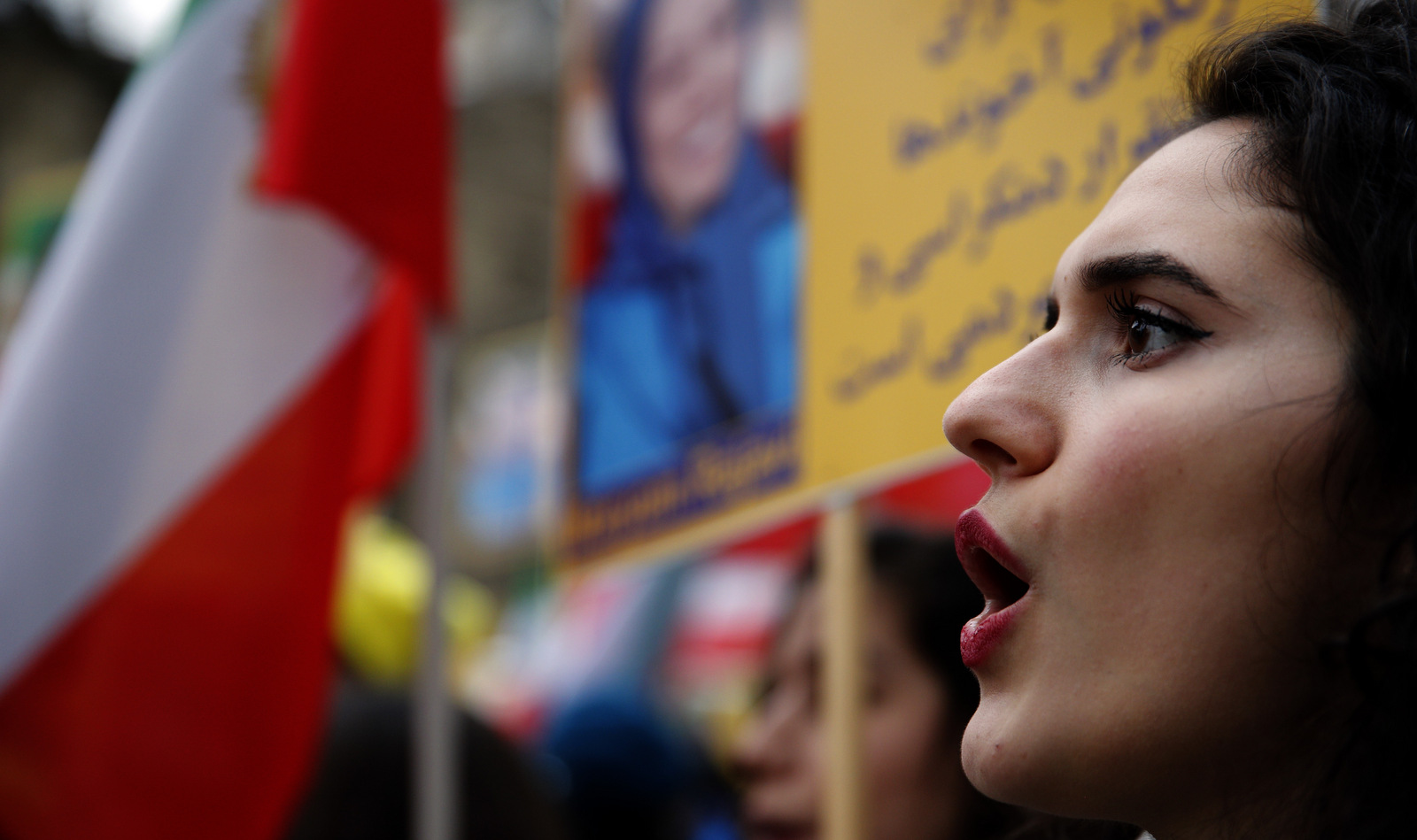 Demonstrators of the National Council of Resistance of Iran protest near the Iran's embassy in Paris, a photo of Maryam Rajavi, former leader of the MEK, is visible in the background, Jan. 6, 2018 (AP/Christophe Ena)