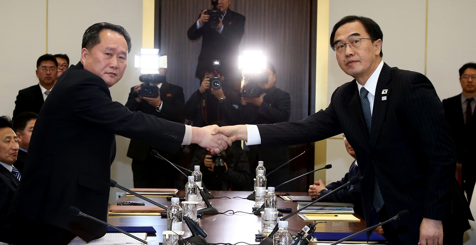 South Korean Unification Minister Cho Myoung-gyon, right, shakes hands with the head of North Korean delegation Ri Son Gwon during their meeting at the Panmunjom in the Demilitarized Zone in Paju, South Korea, Jan. 9, 2018. The rival Koreas took steps toward reducing their bitter animosity during rare talks Tuesday, as North Korea agreed to send a delegation to next month's Winter Olympics in South Korea and reopen a military hotline. (Korea Pool via AP)