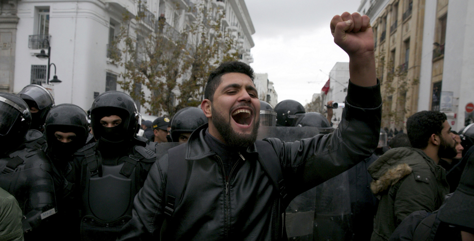 Protesters face riot police during a demonstration in Tunis, Tunisia, Jan. 12, 2018. Tunisia's government says protests over food prices led to days of clashes with police that left one dead, dozens injured and widespread damage. (AP/Hassene Dridi)