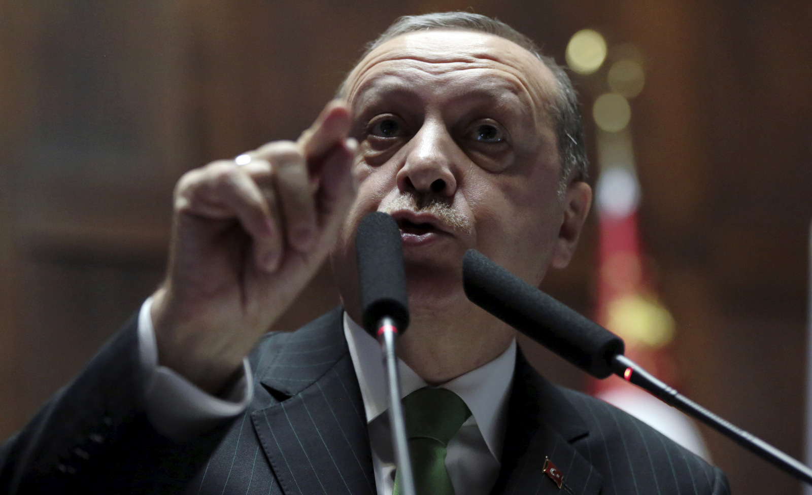 Turkey's President Recep Tayyip Erdogan addresses his lawmakers at the parliament in Ankara, Turkey, where he called on NATO to take a stance against the United States, a fellow ally, over its plans fund and arm a 30,000-strong Kurdish-led militia in Syria, Jan. 16, 2018. (AP/Burhan Ozbilici)