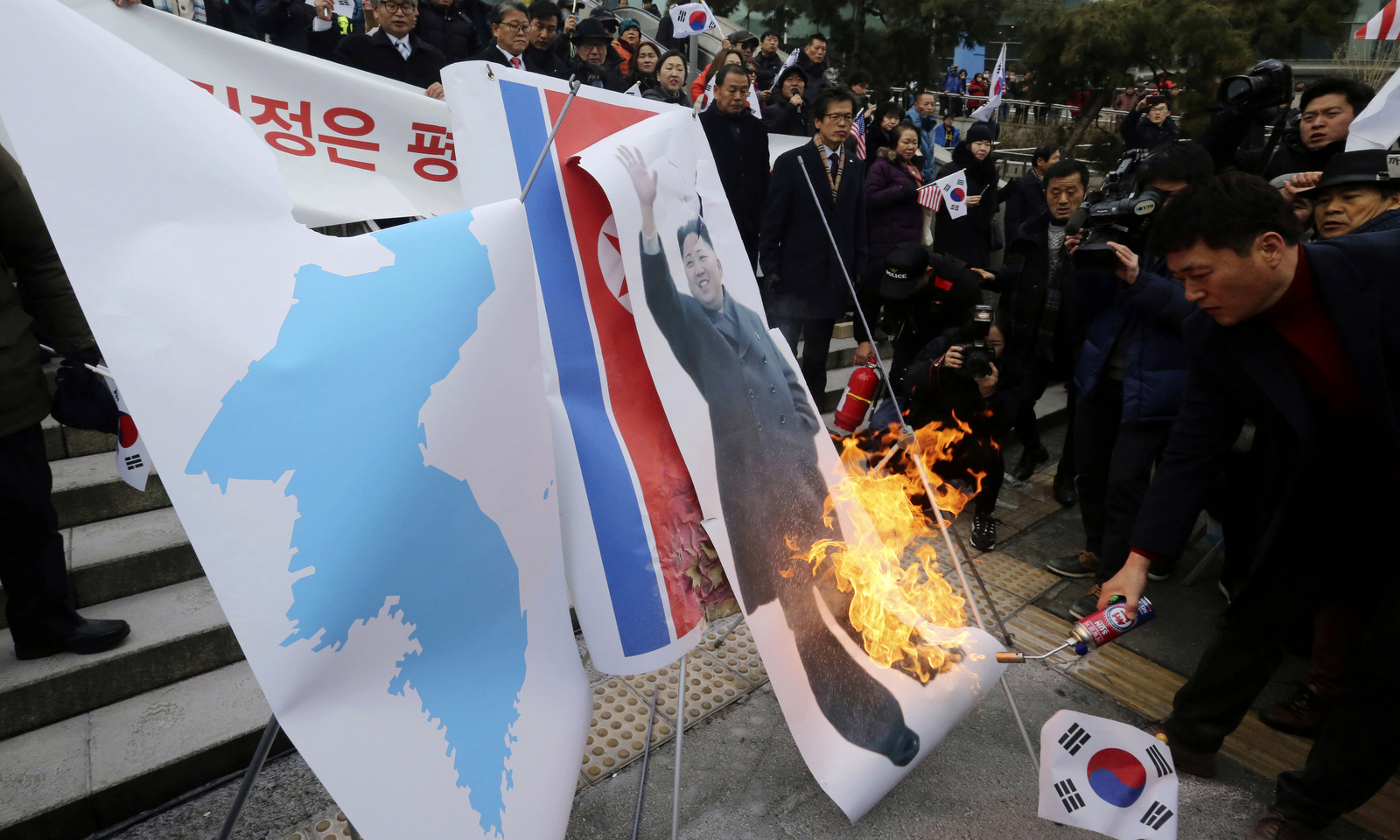 South Korean protesters burn a portrait of North Korean leader Kim Jong-un during a rally against a visit of North Korean Hyon Song Wol, head of North Korea's art troupe in Seoul, South Korea, Jan. 22, 2018. The protesters later burned Kim's photo, a North Korean flag and a Korean unification flag. (AP/Ahn Young-joon)