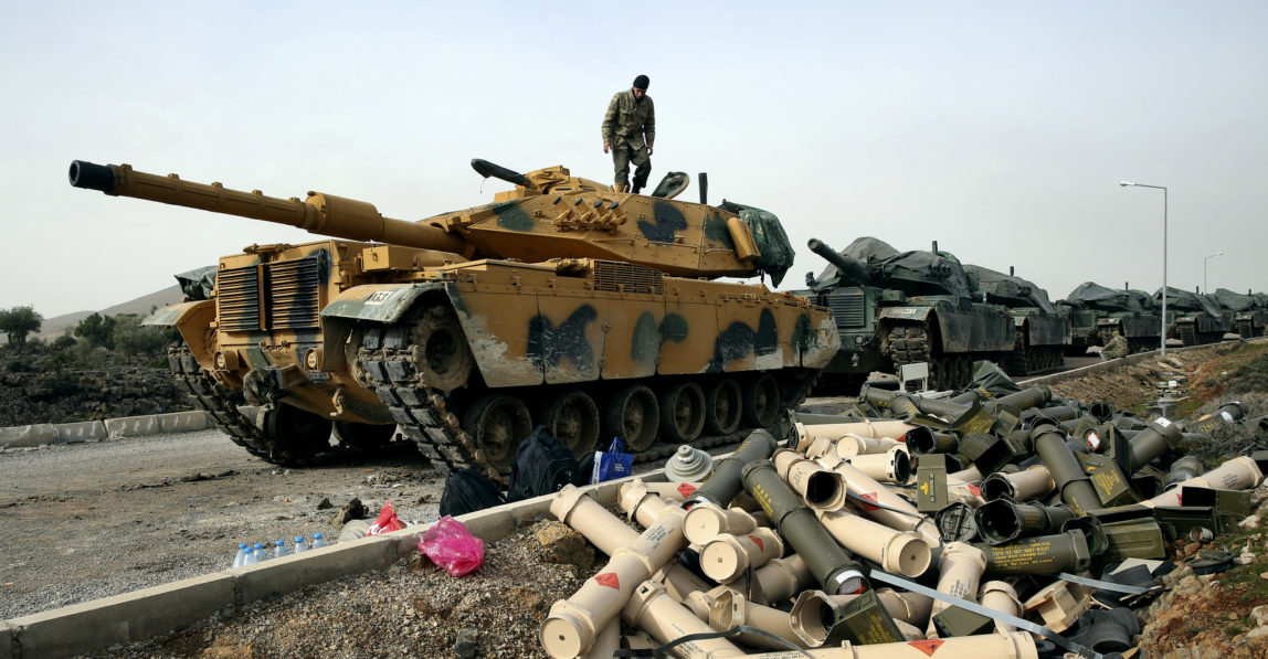 Turkish Army soldiers prepare their tanks next to empty shells at a staging area in the outskirts of the village of Sugedigi, Turkey, on the border with Syria, Jan. 22, 2018. The Turkish offensive on the Kurdish enclave of Afrin in Syria, codenamed Operation Olive Branch, started on Saturday, heightening tensions in the already complicated Syrian conflict and threatening to further strain ties between NATO allies Turkey and the United States. (AP/Lefteris Pitarakis)