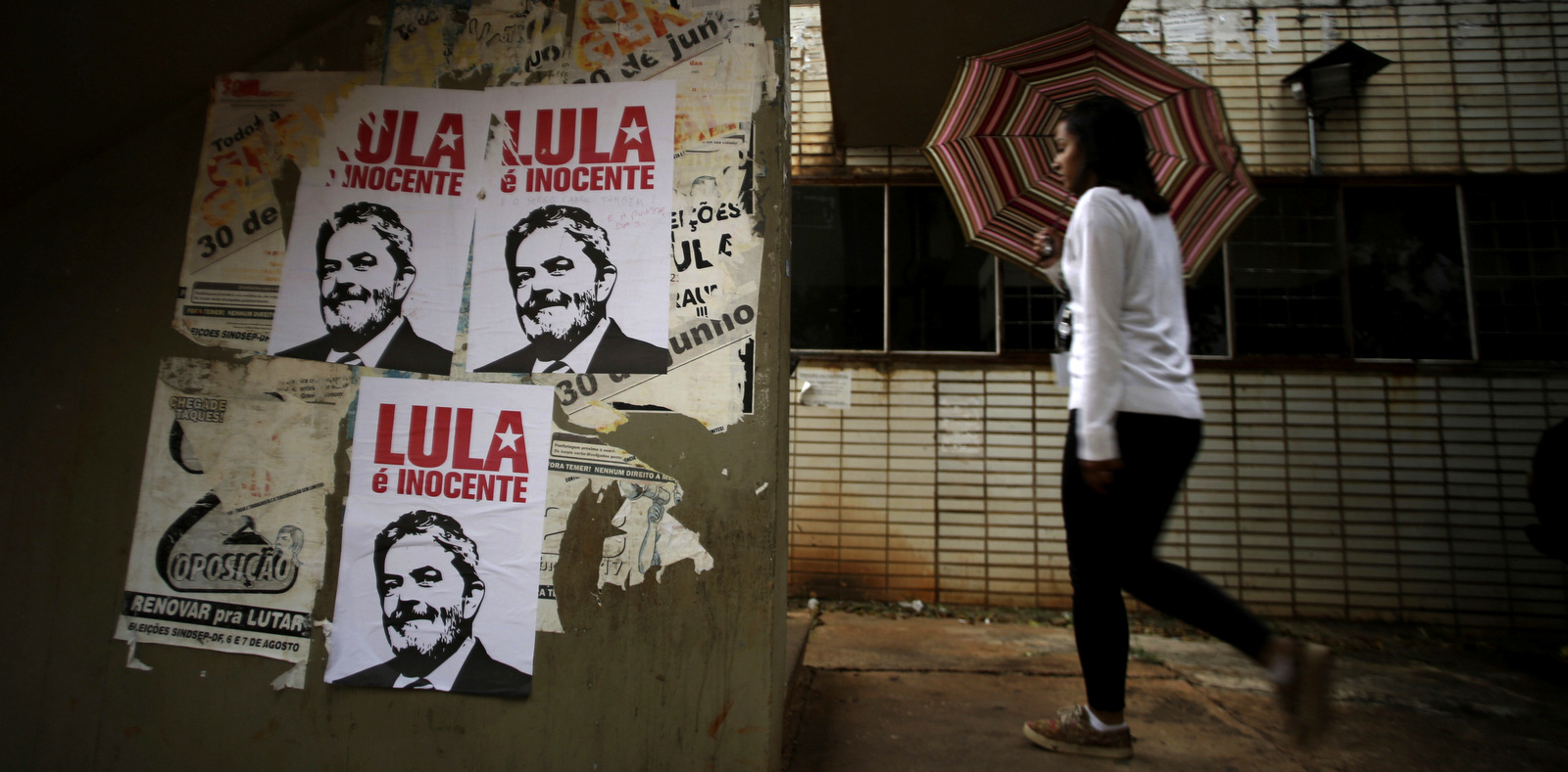 A wall displaying posters with line drawings that depict Brazil's former President Luiz Inacio Lula da Silva and a message that reads in Portuguese, “Lula is innocent”, in Brasilia, Brazil, Jan. 29, 2018. (AP/Eraldo Peres)