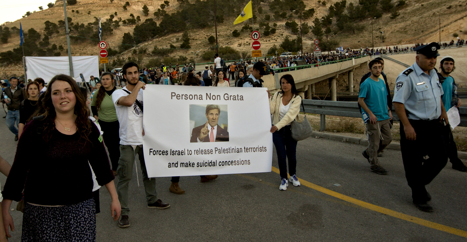 Israelis hold a sign depicting U.S. Secretary of State John Kerry during a march from the Jewish-only settlement of Maaleh Adumim to the E-1 area on the eastern outskirts of Jerusalem, Feb. 13, 2014.(AP/Sebastian Scheiner)