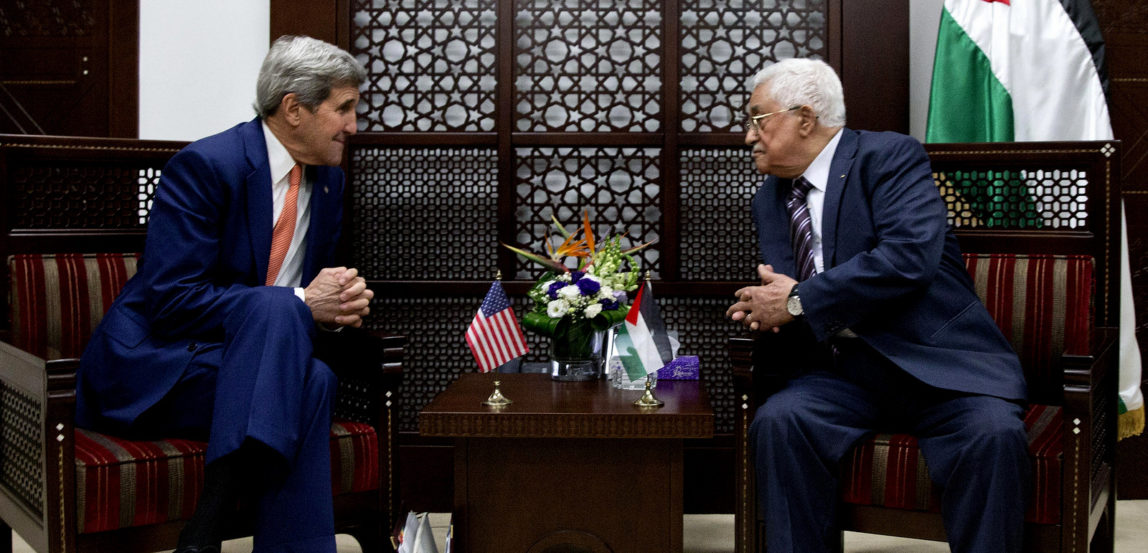U.S. Secretary of State John Kerry, left, leans in to begin his meeting with Palestinian President Mahmoud Abbas in the West Bank city of Ramallah, Nov. 24, 2015. (AP/Jacquelyn Martin)