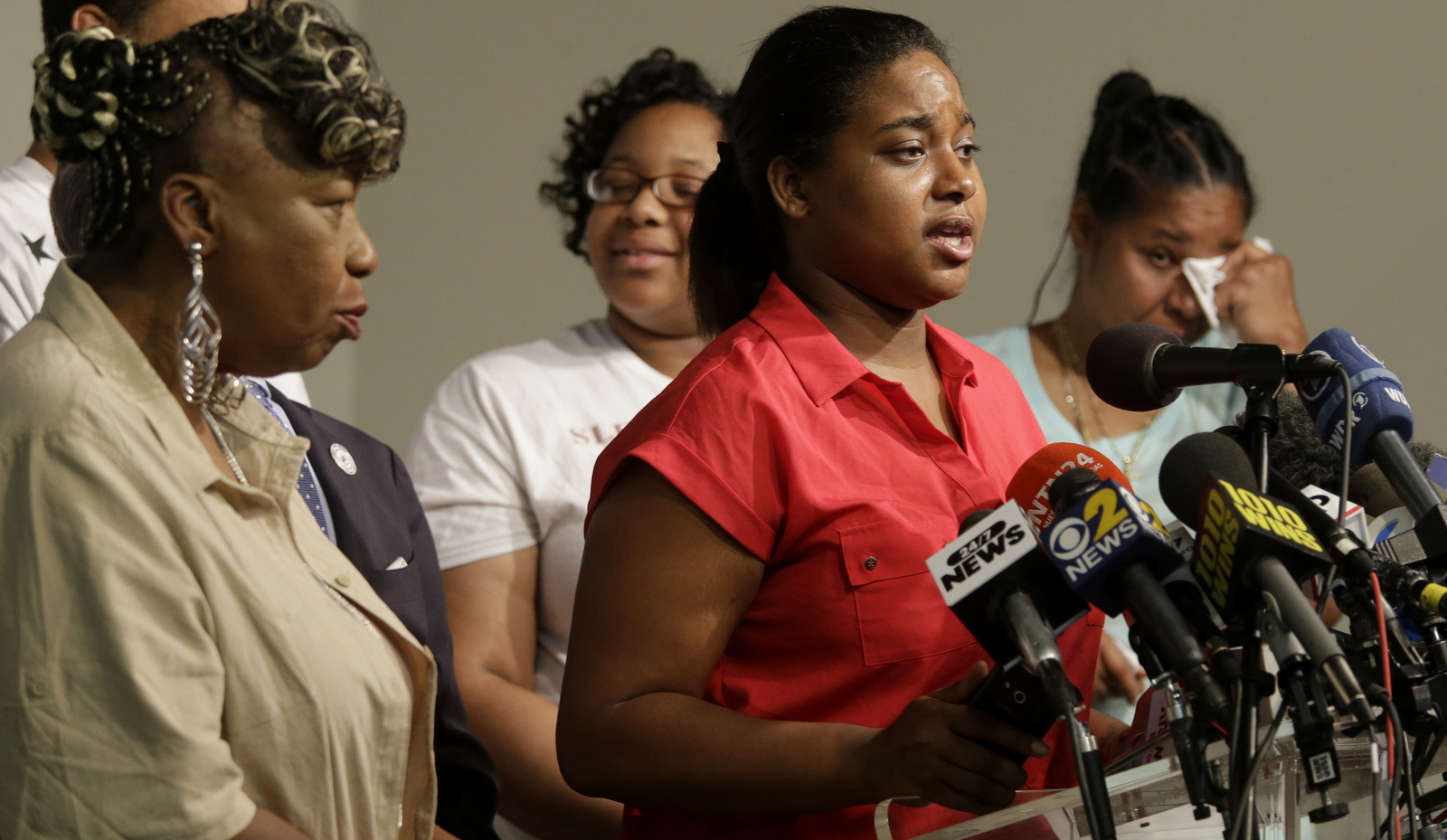 Eric Garner is surrounded by family as she speaks during a news conference, July 14, 2015, in New York, days before the anniversary of her father's death at the hands of the NYPD. (AP/Mary Altaffer)