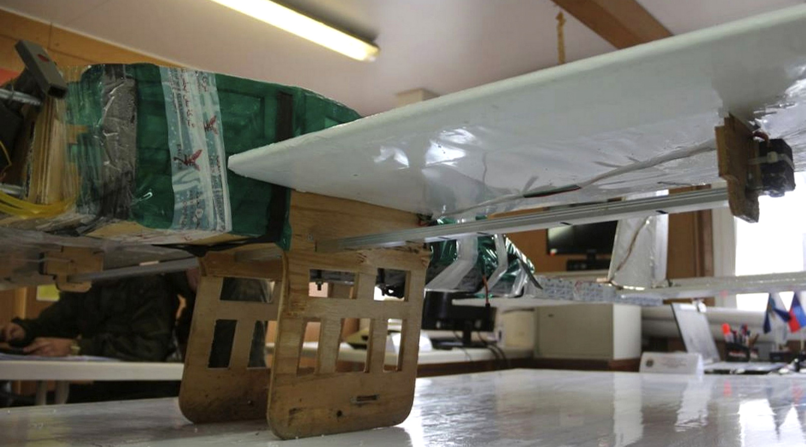 In this photo taken from the Russian Defence Ministry Press Service Facebook page on Tuesday, Jan. 9 2018, one of the drones that was forced to land after an unsuccessful attack attempt sits at a table at Hemeimeem air base in Syria. Russia's Defence Ministry said its forces repelled a series of drone attacks on the Hemeimeem air base and a naval facility in Tartus, adding that such attacks would have required assistance from a country possessing satellite navigation technology — a statement that appeared to be aimed at the United States. (Russian Defence Ministry Press Service photo via AP)