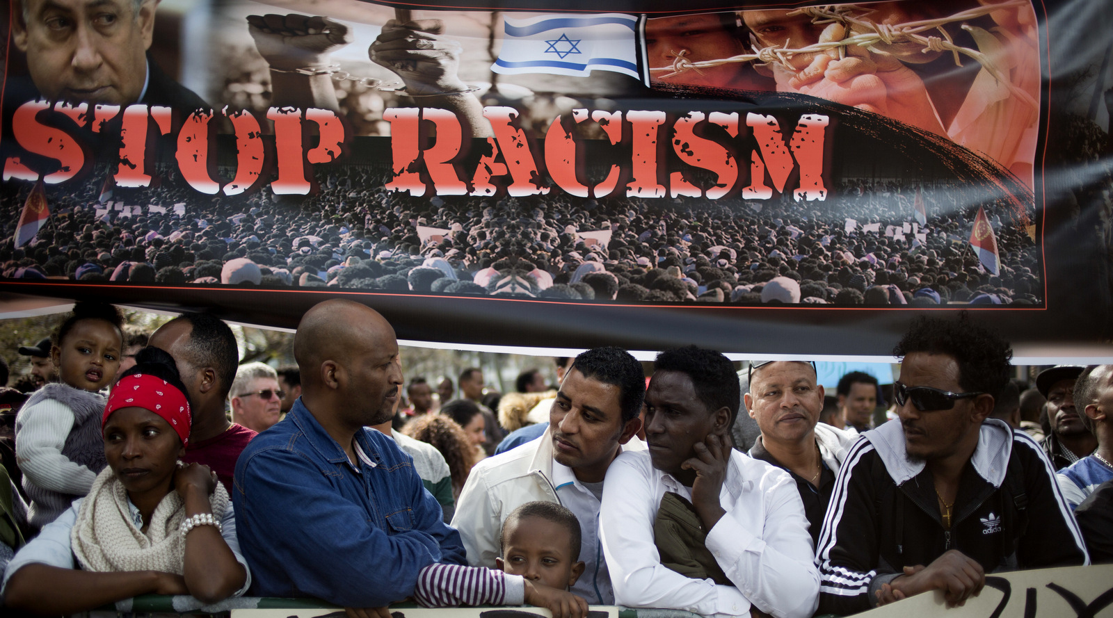 African migrants hold signs during a protest in front of Rwanda embassy in Herzeliya, Wednesday, Feb. 7, 2018. African asylum seekers are protesting an Israeli plan to deport them.Israel says thousands of migrants have 60 days to accept an offer to leave the country for an unnamed African destination -- known to be Rwanda -- in exchange for $3,500 and a plane ticket. Those who don't by April 1 will be incarcerated indefinitely. (AP Photo/Ariel Schalit)