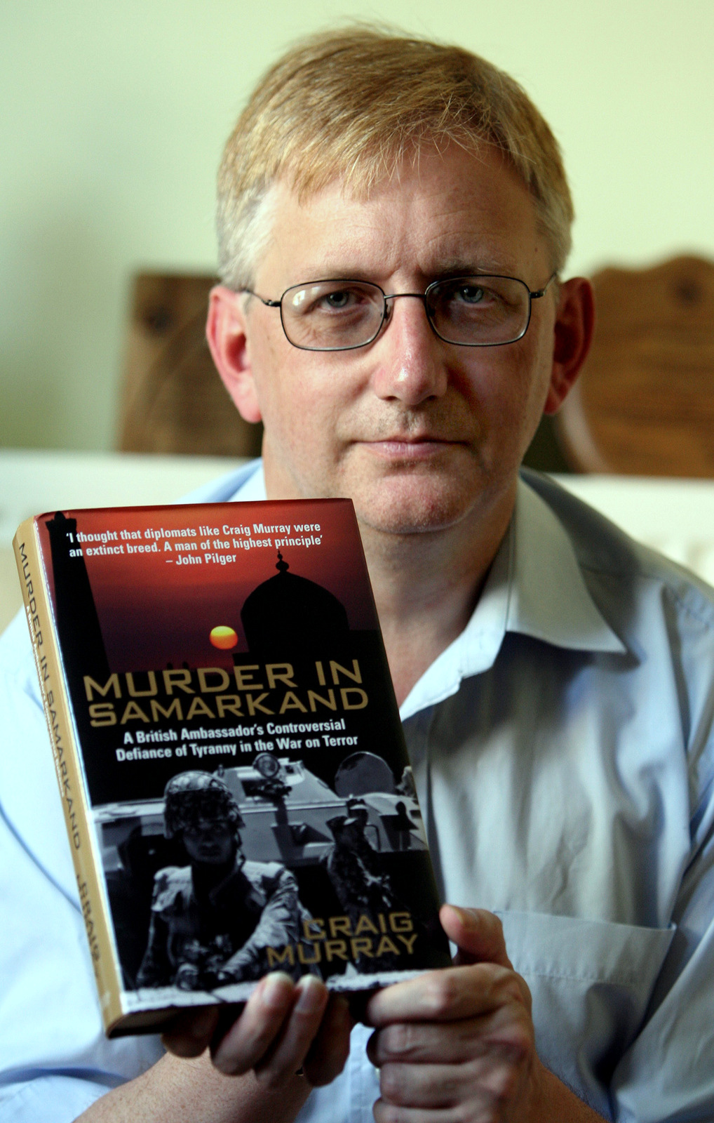 Former British Ambassador Craig Murray with his book, Murder in Samarkand. Murray was the British ambassador to Uzbekistan until he was removed from his post in October 2004 for exposing human-rights abuses by the US backed regime of President Islam Karimov. (AP/Simon Dawson)