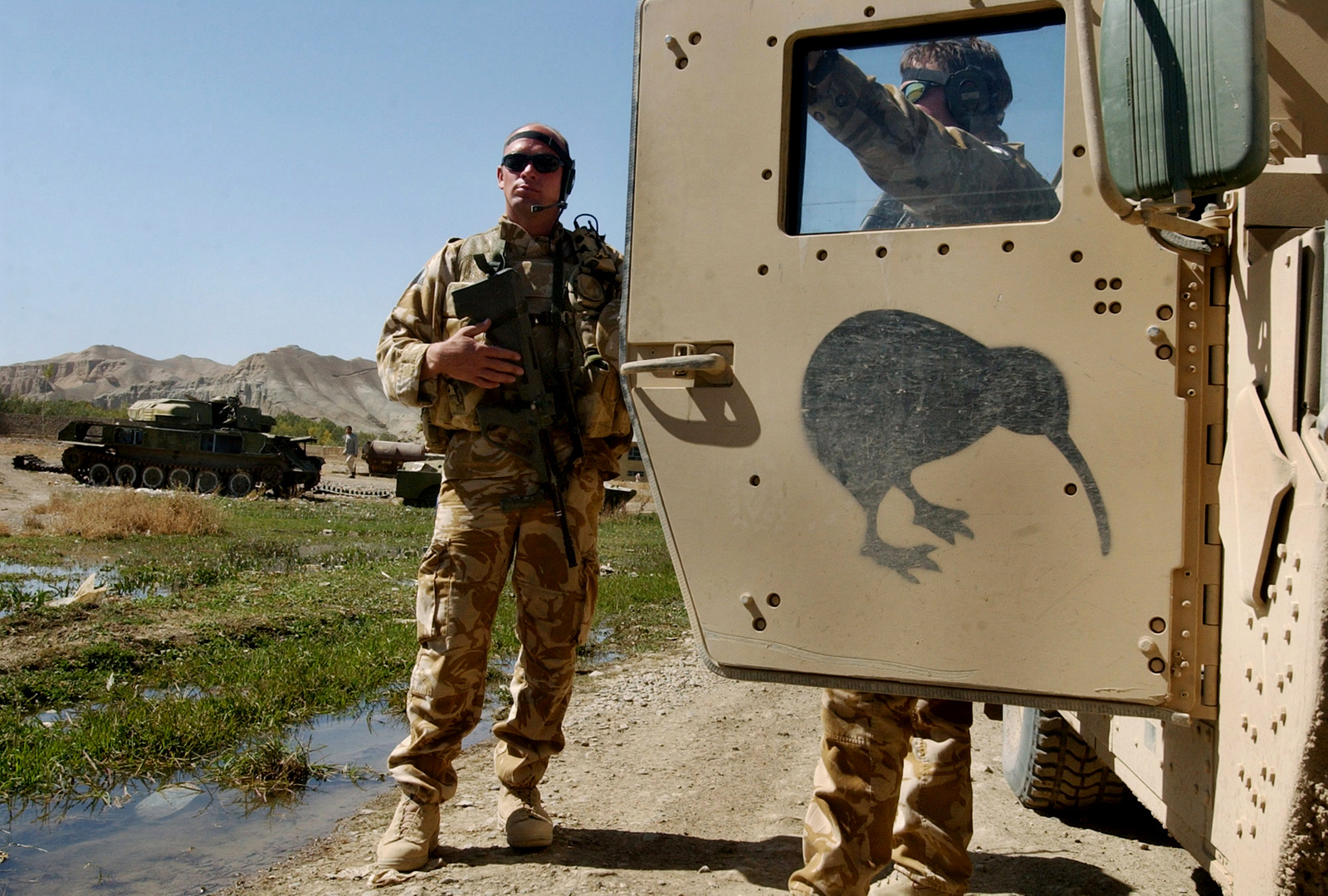 New Zealand soldiers stand near their Humvee in Bamyan, north west of Kabul, Afghanistan, Oct. 5, 2006. (AP/Musadeq Sadeq)