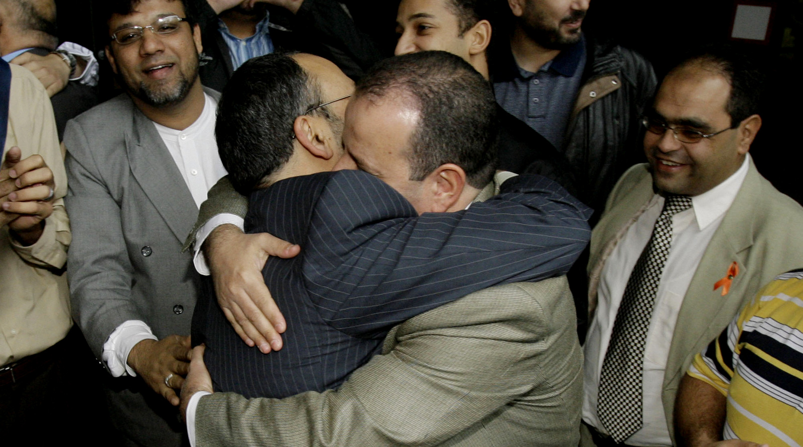 Defendants Shukri Abu Baker, center left, and Abdulrahman Odeh, hug after a mistrial was declared in the Holy Land Foundation trial at the federal courthouse, Oct. 22, 2007, in Dallas. (AP/Matt Slocum)
