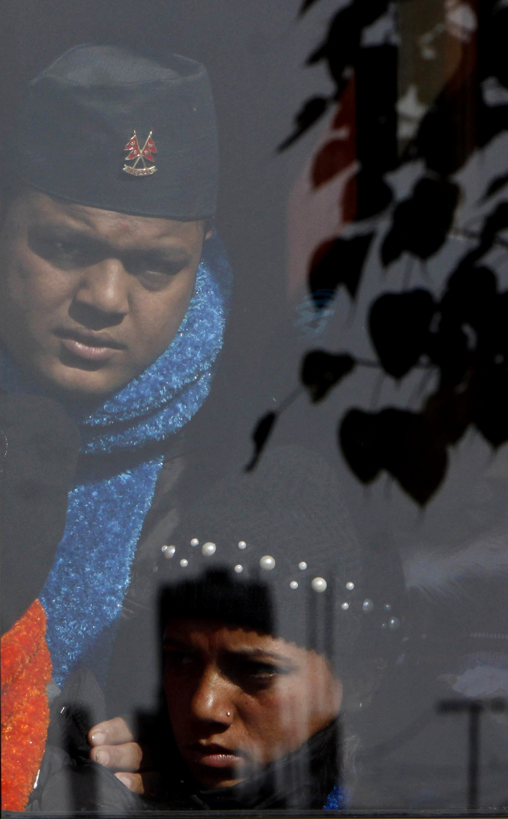 Bhutanese refugees watch their colleagues leave for resettlement abroad at a transit facility of International Organization for Migration in Katmandu, Nepal, Dec. 13, 2010. (AP/Binod Joshi)