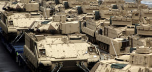 U.S. Army M2A2 and M2A3 Bradley fighting vehicles are unloaded at a pier in Busan, South Korea, June 29, 2011. (AP/Yonhap, Kim Sun-ho)