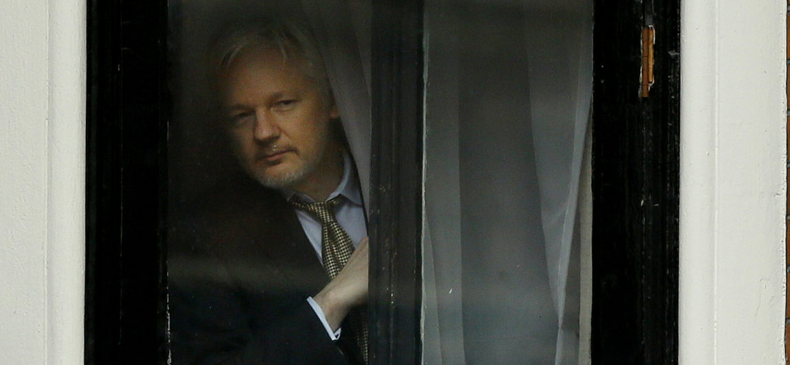 Wikileaks founder Julian Assange appears at the window before speaking on the balcony of the Ecuadorean Embassy in London, Friday, Feb. 5, 2016. (AP/Kirsty Wigglesworth)