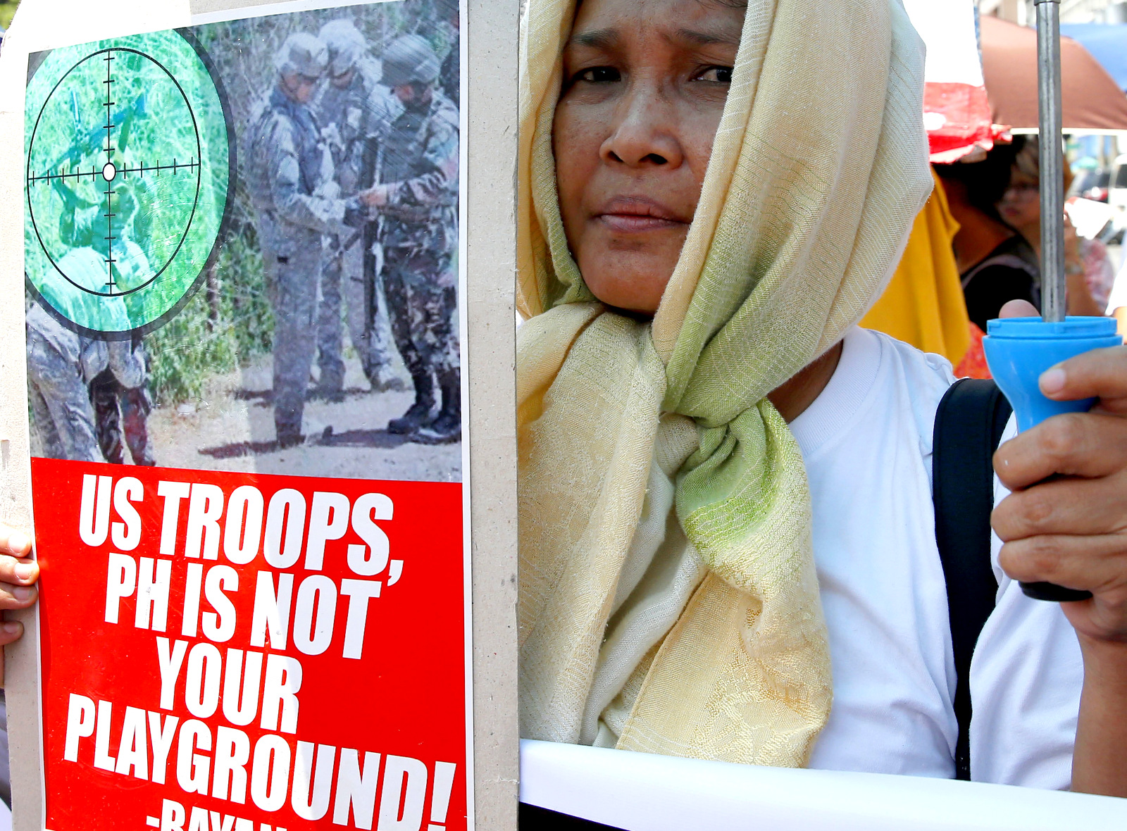 A protester holds a placard during a rally in Manila, Philippines, near the U.S. Embassy to denounce the U.S. military's role in the battle between government forces and Islamist militants. The protesters also denounced President Rodrigo Duterte's declaration of martial law in the whole region of Mindanao in southern Philippines. (AP Photo/Bullit Marquez)