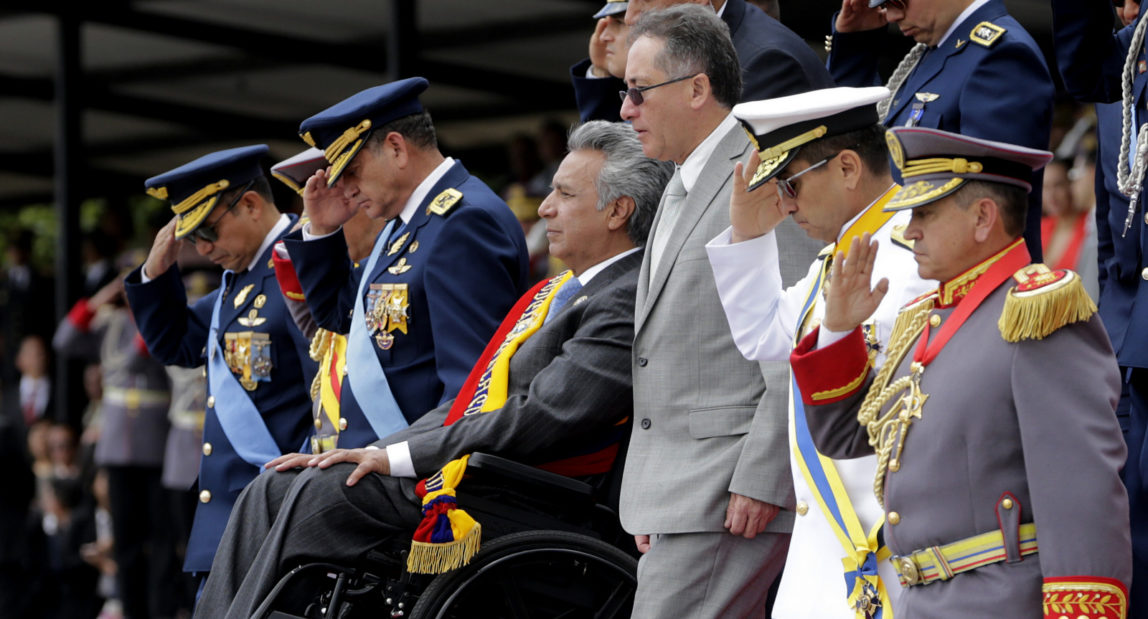 Ecuador's President Lenin Moreno, sitting in a wheelchair, leaves a military ceremony marking Independence Day in Quito, Ecuador. (AP/Dolores Ochoa)