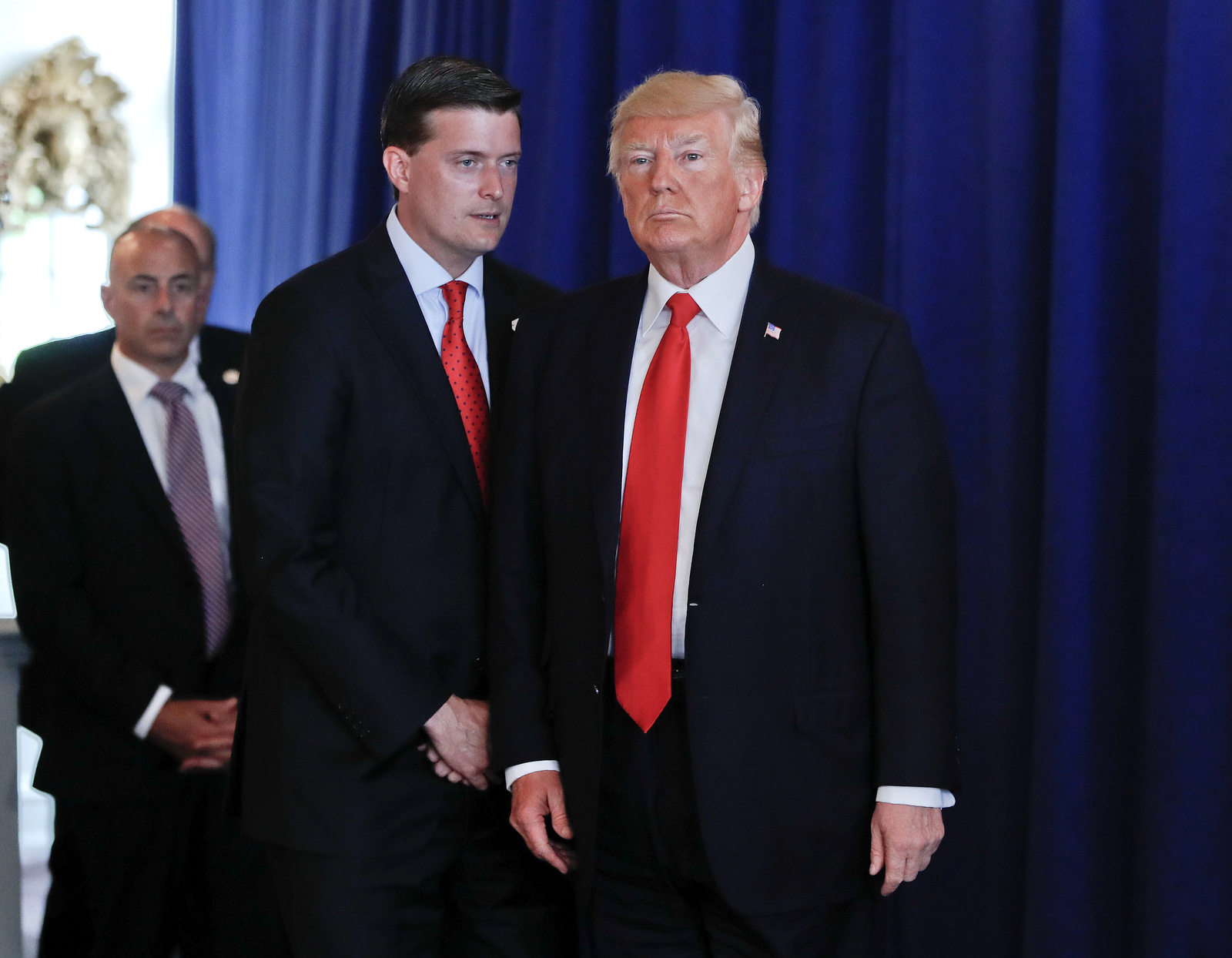 Rob Porter, left, speaks to Donald Trump after he made remarks regarding the on going situation in Charlottesville, Va., Aug. 12, 2017 at Trump National Golf Club in Bedminister, N.J. (AP/Pablo Martinez Monsivais)