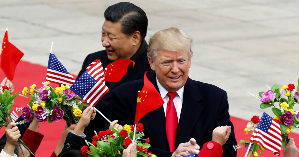U.S. President Donald Trump, right, and Chinese President Xi Jinping are greeted by children waving flowers and flags during a welcome ceremony at the Great Hall of the People in Beijing, Nov. 9, 2017. (AP/Andy Wong)