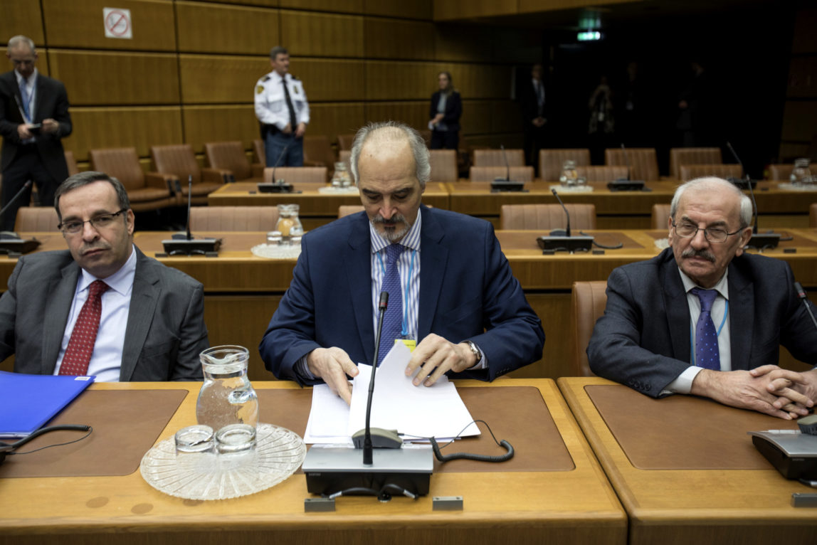 Syrian chief negotiator and Ambassador of the Permanent Representative Mission of Syria to the United Nations, Bashar al-Jaafari, centre, sits sits with members of Syrian delegation before the start of official talks on Syria, in Vienna, Austria, Jan. 25, 2018. (Alex Halada/AP)
