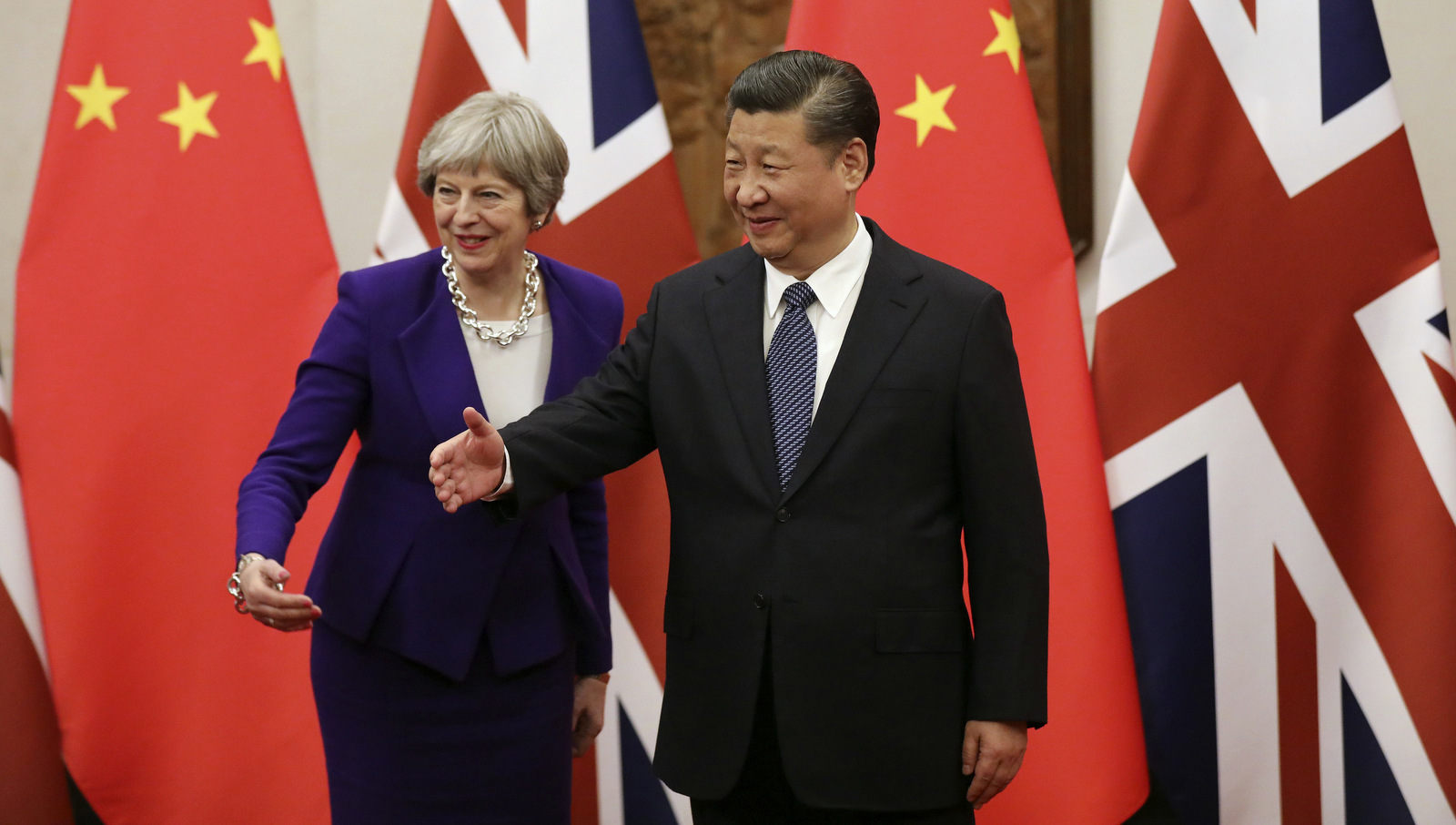 Chinese President Xi Jinping, right, and British Prime Minister Theresa May gesture ahead a meeting at the Diaoyutai State Guesthouse in Beijing, Feb. 1, 2018. (Wu Hong/AP)