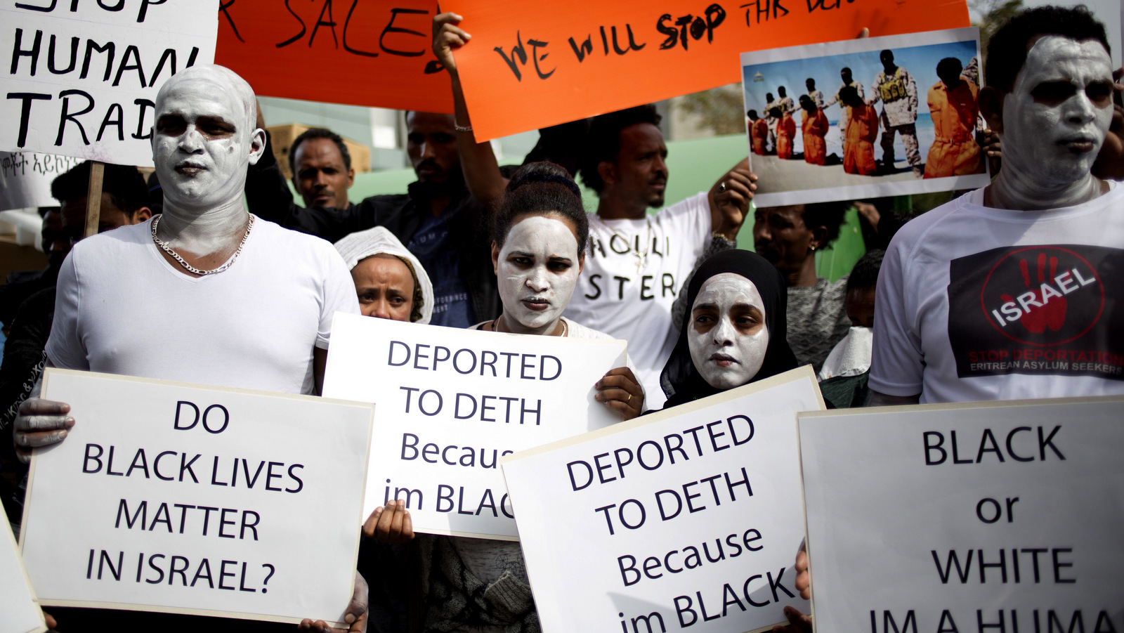 African migrants hold signs during a protest in front of Rwanda embassy in Herzeliya, Feb. 7, 2018. African refugess are protesting an Israeli plan to forcefully deport them. Israel has given 60 days to accept an offer to leave the country for an unknown African destination in exchange for $3,500 and a plane ticket. Those who don't by April 1 will be jailed indefinitely. (AP/Ariel Schalit)