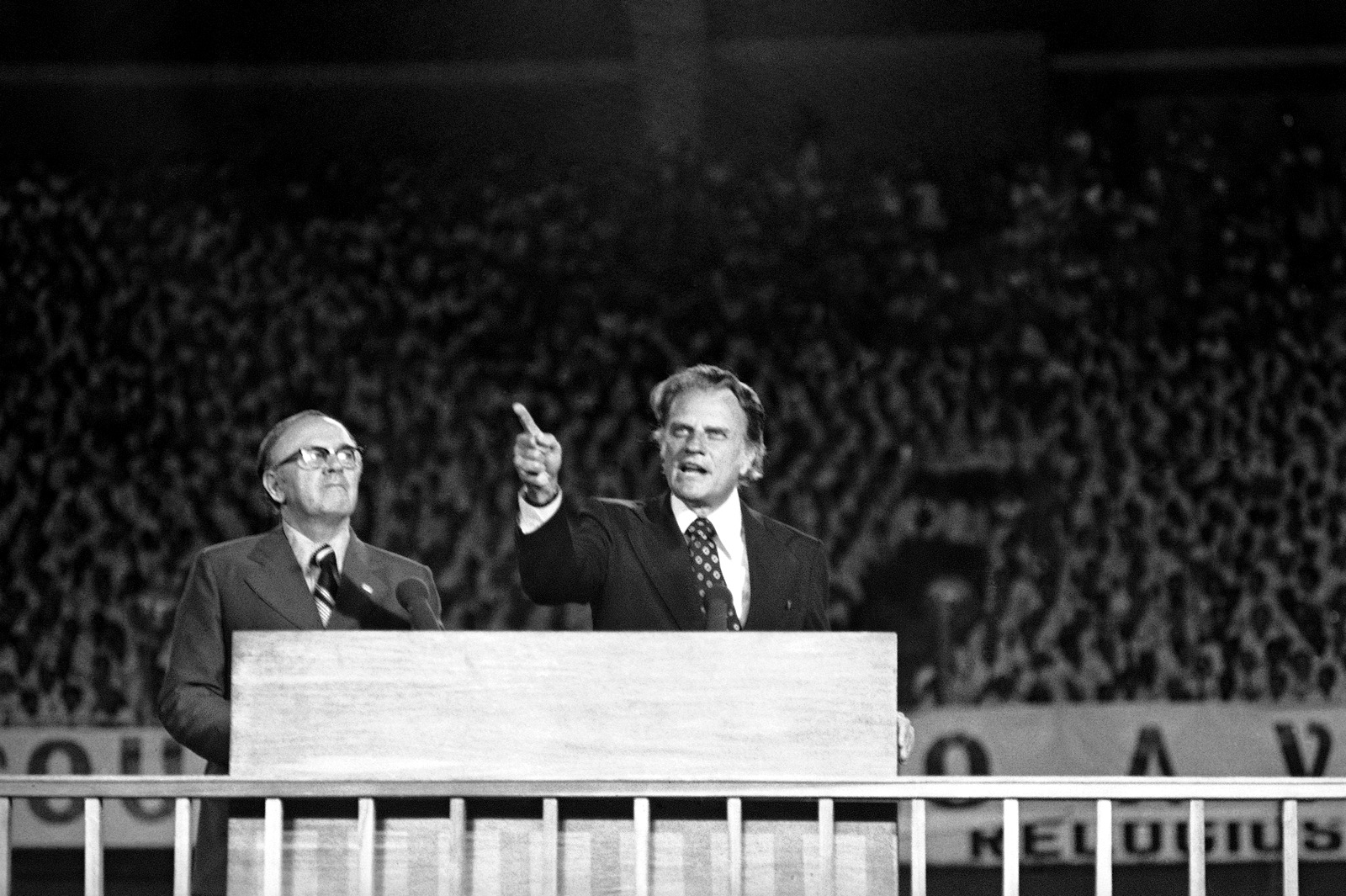 Rev. Billy Graham, flanked by his Portuguese interpreter, told a crowd of 85,000 persons in Rio’s Maracana Stadium in Rio De Janeiro, Oct. 3, 1974, that many of our world leaders are warning about a third world war man has proven himself to be a moral failure. God is the only hope at this hour. (AP Photo)
