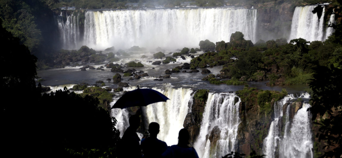 Tourists visit Iguazu Falls in Brazil. The falls are part of the world's largest reservoir of fresh water, known as the Guarani Aquifer. They are in the middle of thick jungle that has more than 1,000 plant and hundreds of animal species., March 15, 2015.(AP/Jorge Saenz)