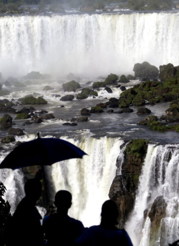 Tourists visit Iguazu Falls in Brazil. The falls are part of the world's largest reservoir of fresh water, known as the Guarani Aquifer. They are in the middle of thick jungle that has more than 1,000 plant and hundreds of animal species., March 15, 2015.(AP/Jorge Saenz)