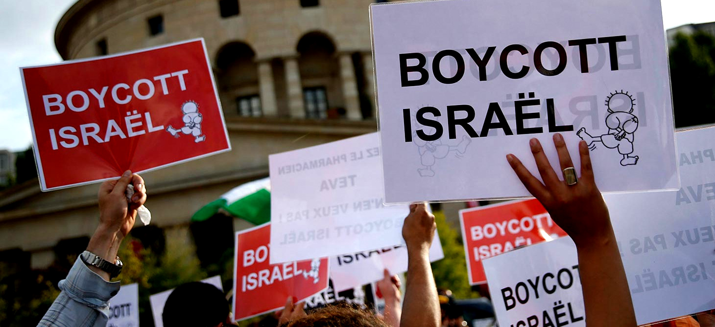 Protesters hold up placards reading 'Boycott Israel' during a demonstration showing solidarity with Palestinians in Paris, France, 31 July 2014. (Christpohe Karaba/EPA)