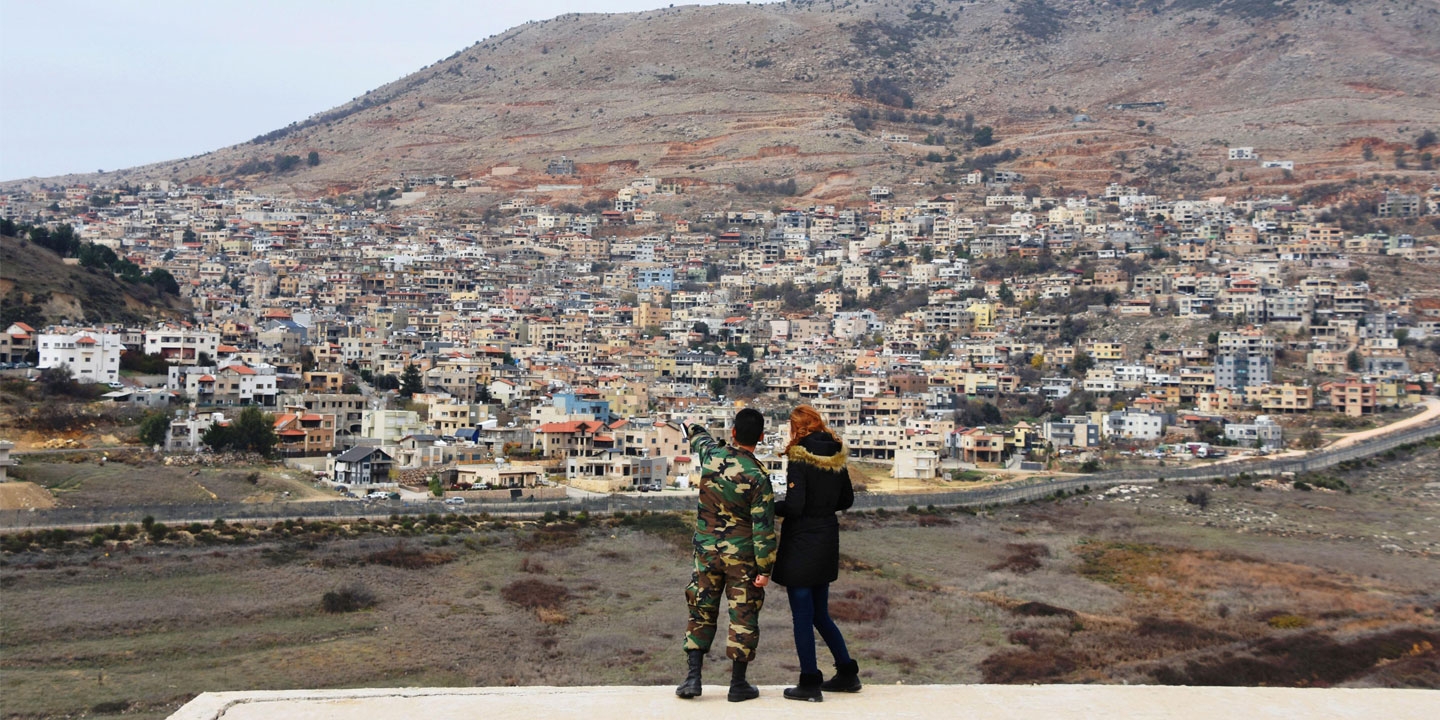 A Syrian military spokesperson (L) points to the Israeli-occupied Golan Heights on Dec. 23, 2017, in Al Gunaytirah in southwestern Syria. (Kyodo via AP Images)