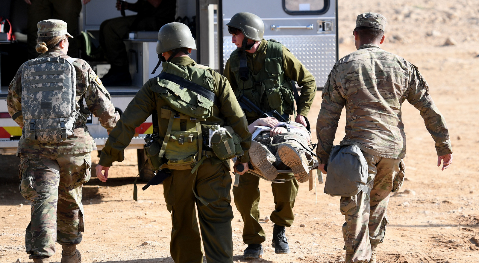 Soldiers from the U.S. Army and the Israel Defense Force (IDF carry a litter with a mock patient during a mass casualty training as part of the combined missile defense exercise known as Juniper Cobra 18, Feb. 28, 2018. (U.S. Navy photo)