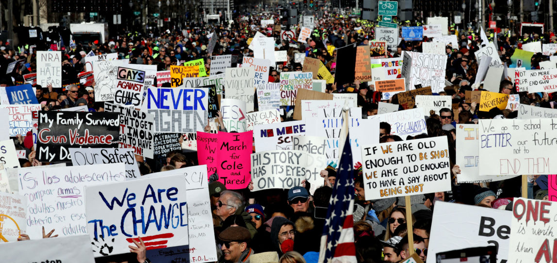Crowds of people hold signs on Pennsylvania Avenue at the "March for Our Lives" rally in support of gun control, Saturday, March 24, 2018, in Washington. (AP Photo/Alex Brandon)