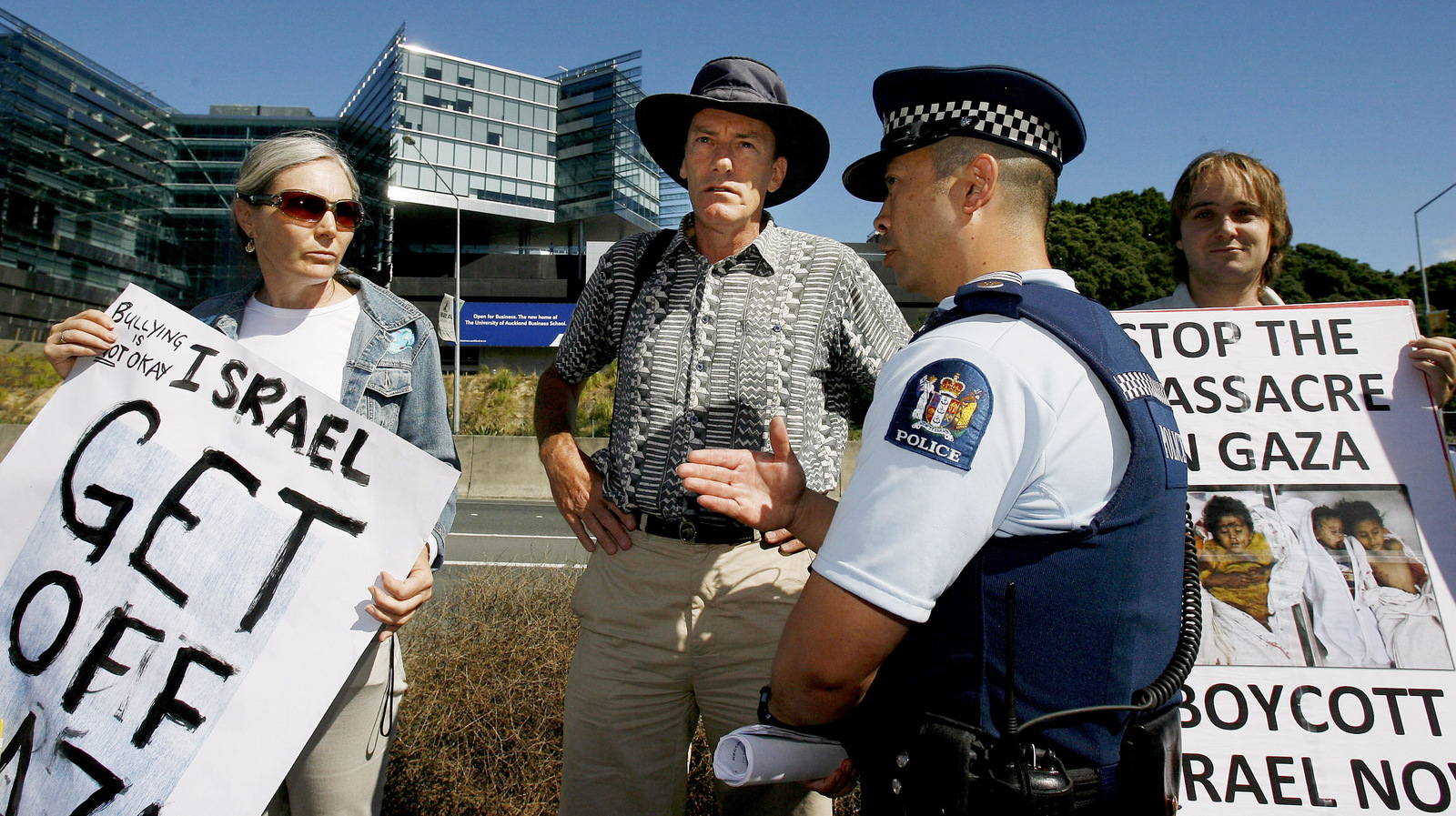 A police officer talks to protesters outside the ASB Tennis Classic in Auckland, New Zealand, Jan. 8, 2008. New Zealanders protested Israeli player Shahar Peer's participation in the tournament following Israel's bombing of a United Nations school in a Gaza refugee camp. (AP/New Zealand Herald, Greg Bowker)