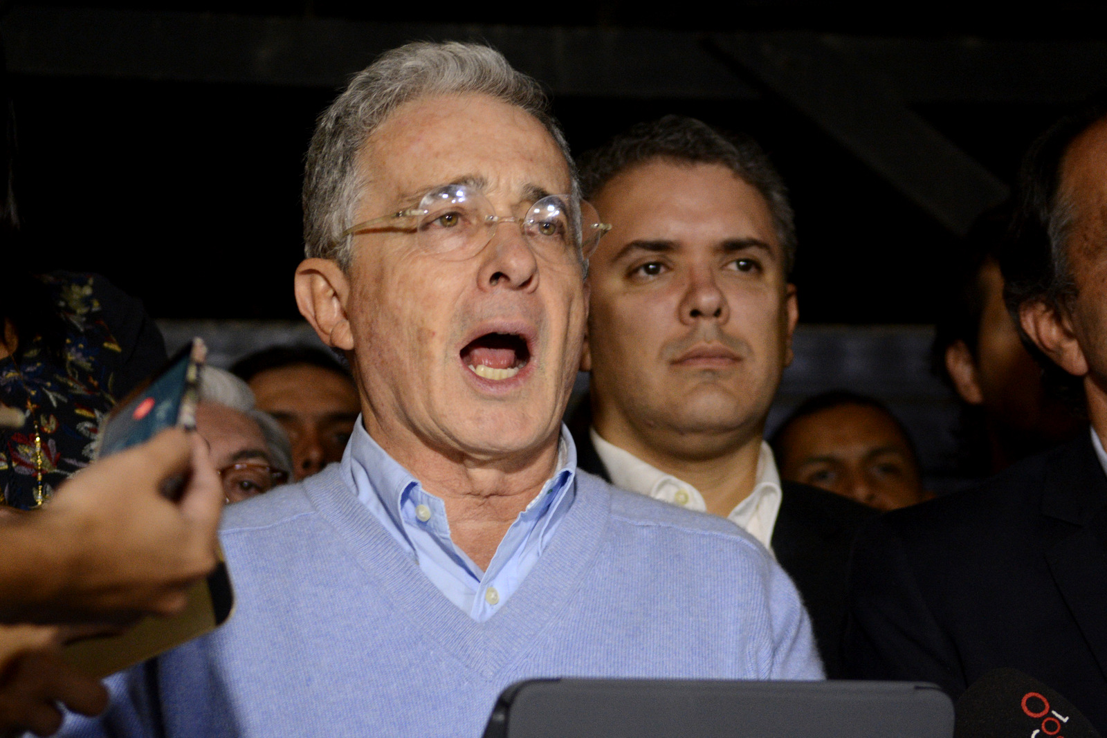Former President Alvaro Uribe, flanked by presidential candidate Ivan Duque, reads a statement at his house in Rionegro, Colombia, Oct. 2, 2016. (AP/Luis Benavides)