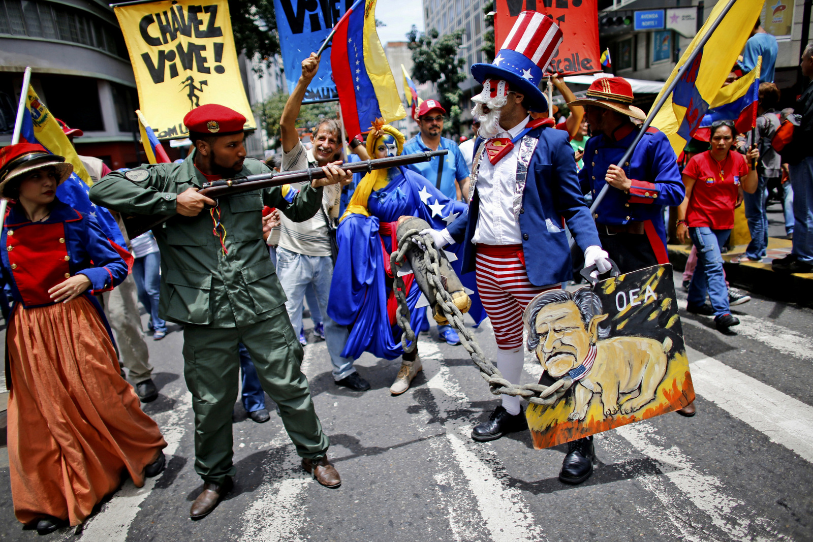Government supporters perform a parody involving a Venezuelan militia up against Uncle Sam, a personification of the U.S government, during an anti-imperialist march to denounce Trump's talk of a "military option" for resolving the country's political crisis, in Caracas, Venezuela, Aug. 14, 2017. (AP/Ariana Cubillos)