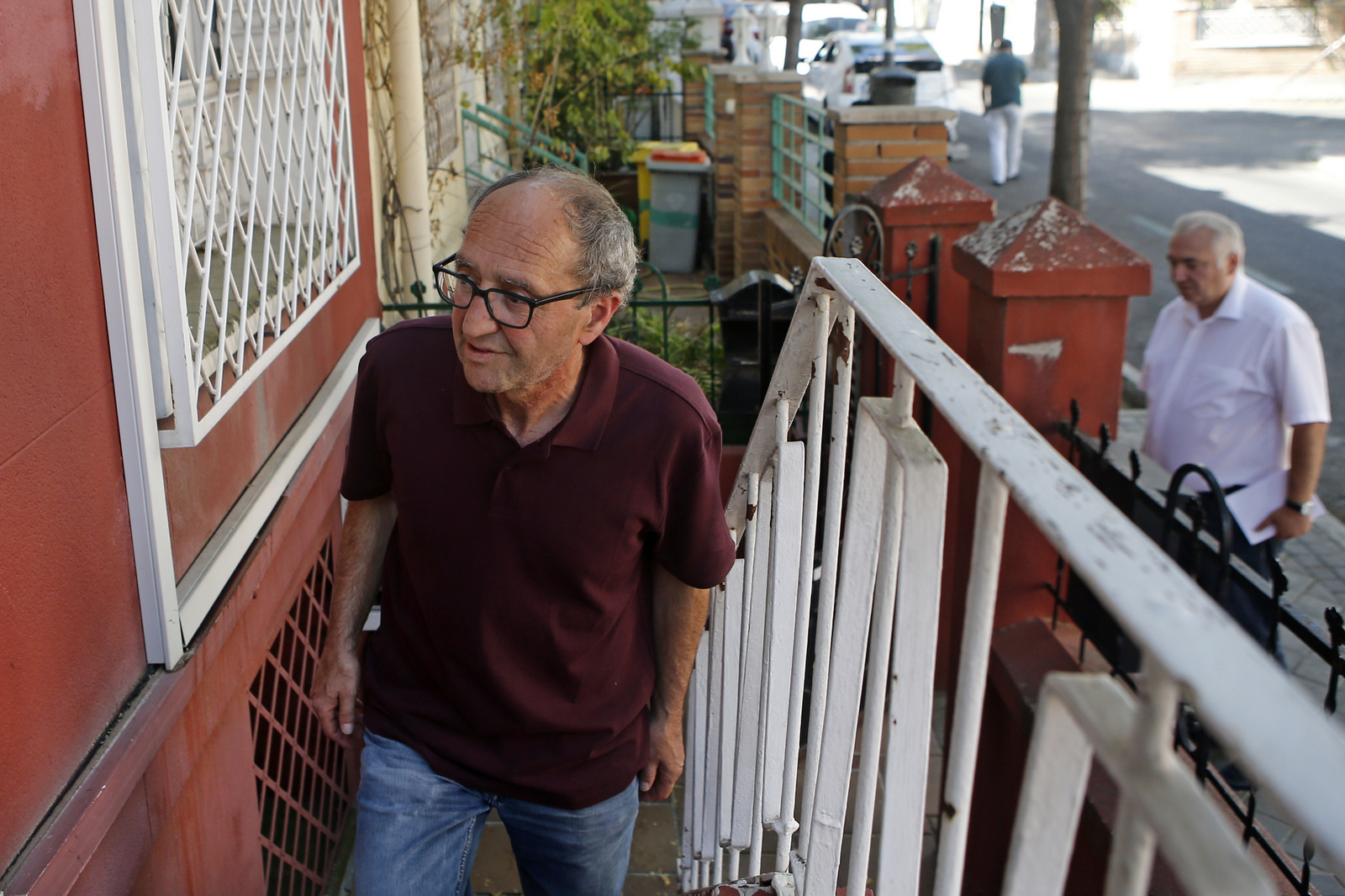 Turkish-born German writer Dogan Akhanli followed by his lawyer Ilias Uyar, enters his lawyer's office in Madrid, Spain, Aug. 21, 2017. Akhanli was detained in Spain on a Turkish warrant, and accused Turkey of abusing the international system used to hunt down fugitives. (AP/Paul White)