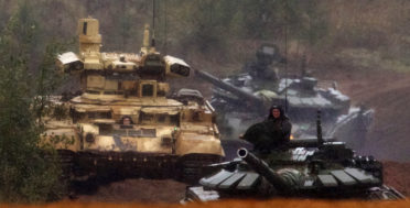 A Russian military combat vehicle, left, and tanks roll during a military exercise at a training ground at the Luzhsky Range, near St. Petersburg, Russia, Sept. 18, 2017. The Zapad (West) 2017 maneuvers have caused concern among some NATO members neighboring Russia, who have criticized a lack of transparency about the exercises and questioned Moscow's real intentions. (AP/Ivan Sekretarev)