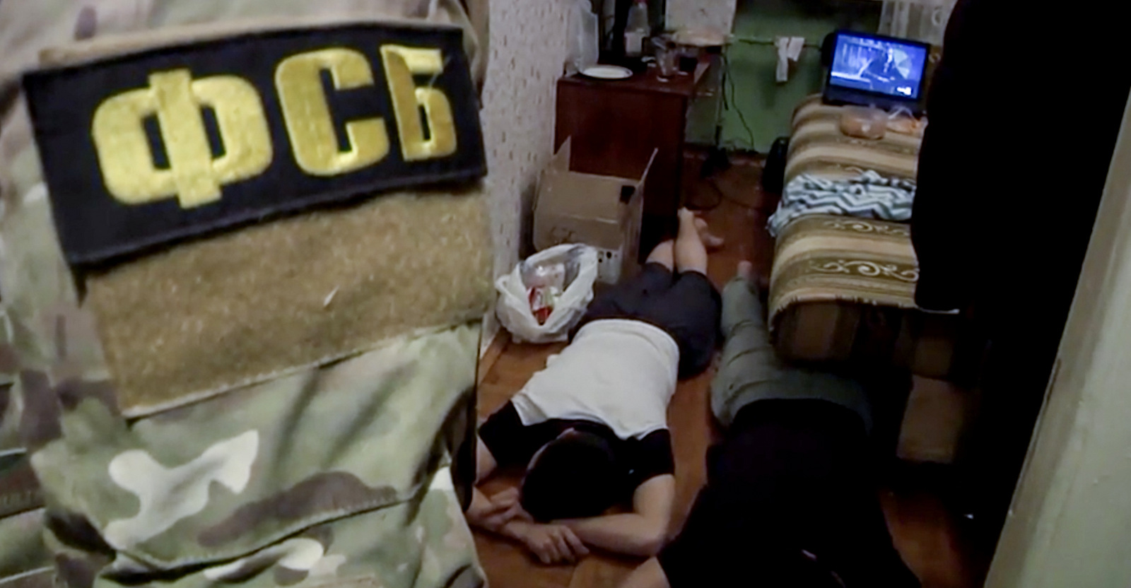 Russian Federal Security Service (FSB) operatives detain suspects in their apartment. (FILE - Russian Federal Security Service/AP)